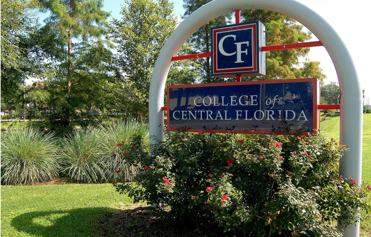 Entrance sign for the College of Central Florida surrounded by greenery and flowers on the Ocala campus.
