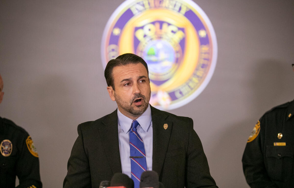 Mayor Ben Marciano speaks at a press conference with Ocala Police Department officials in front of a police emblem.