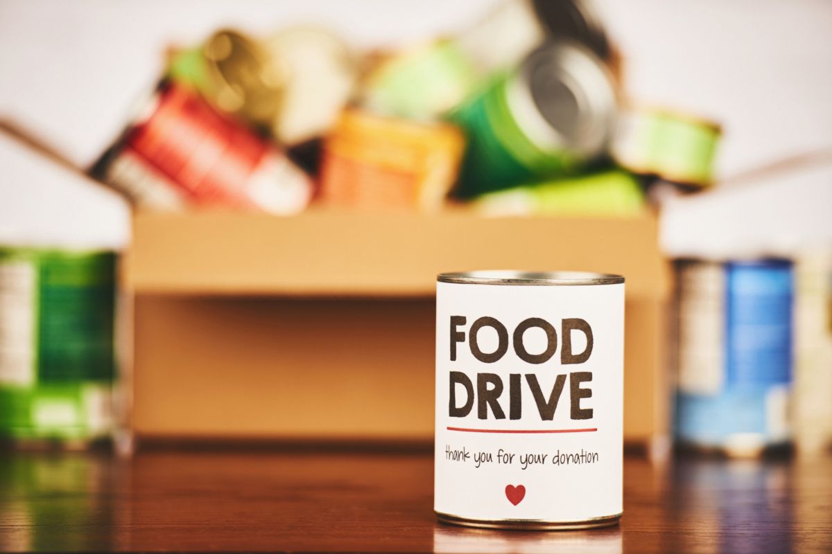 A box filled with nonperishable food items, including canned goods, pasta, and cereal, is ready for donation at a local food drive.