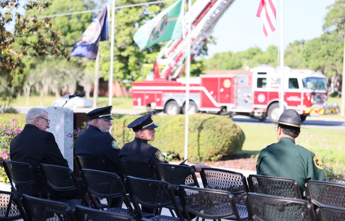 Belleview Police Department Chief Terry Holland (far left with hat) sits next to Ocala Police Chief Mike Balken (middle) and Marion County Sheriff Billy Woods (right).