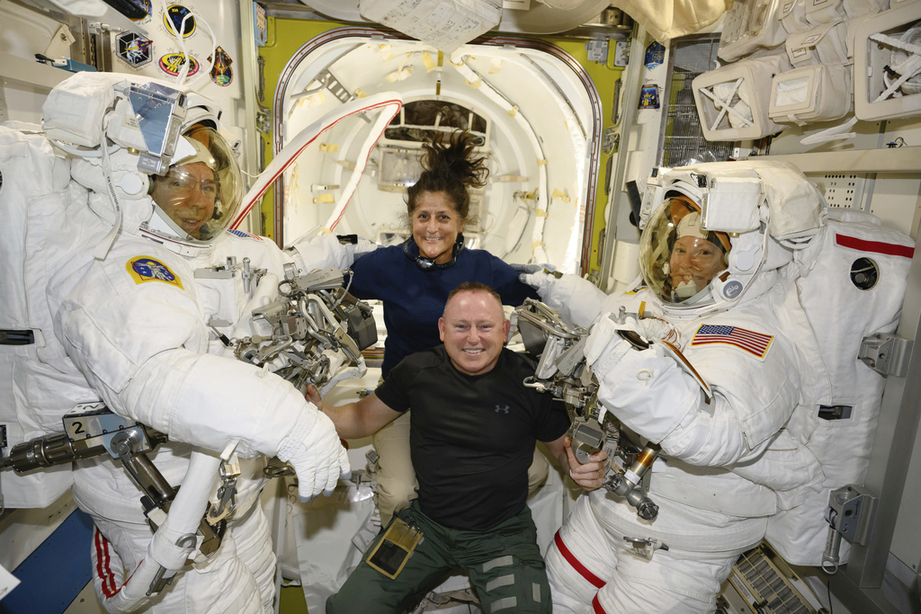 In this photo provided by NASA, Boeing Crew Flight Test astronauts Suni Williams and Butch Wilmore, center, pose with Expedition 71 Flight Engineers