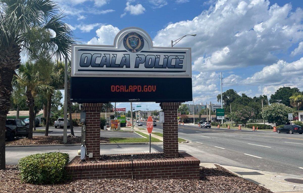 Sign outside Ocala Police Department on a sunny day, promoting ocalaPD.gov.