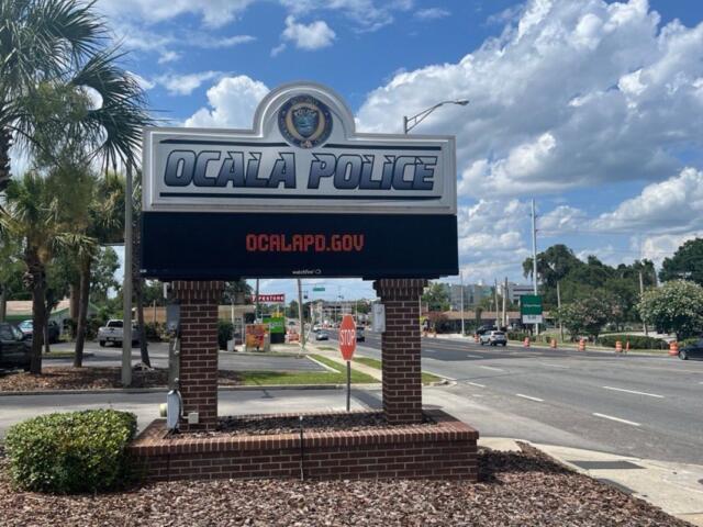 Sign outside Ocala Police Department on a sunny day, promoting ocalaPD.gov.
