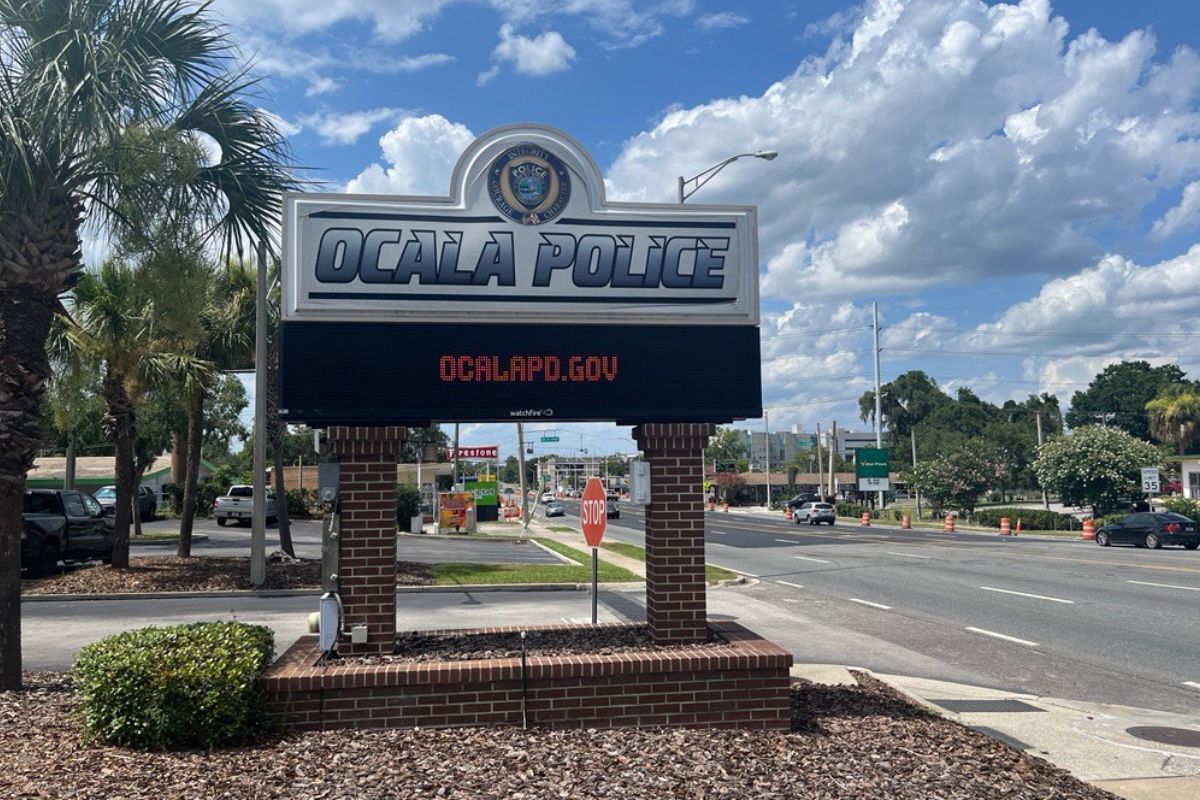 Sign outside Ocala Police Department on a sunny day, promoting ocalaPD.gov.