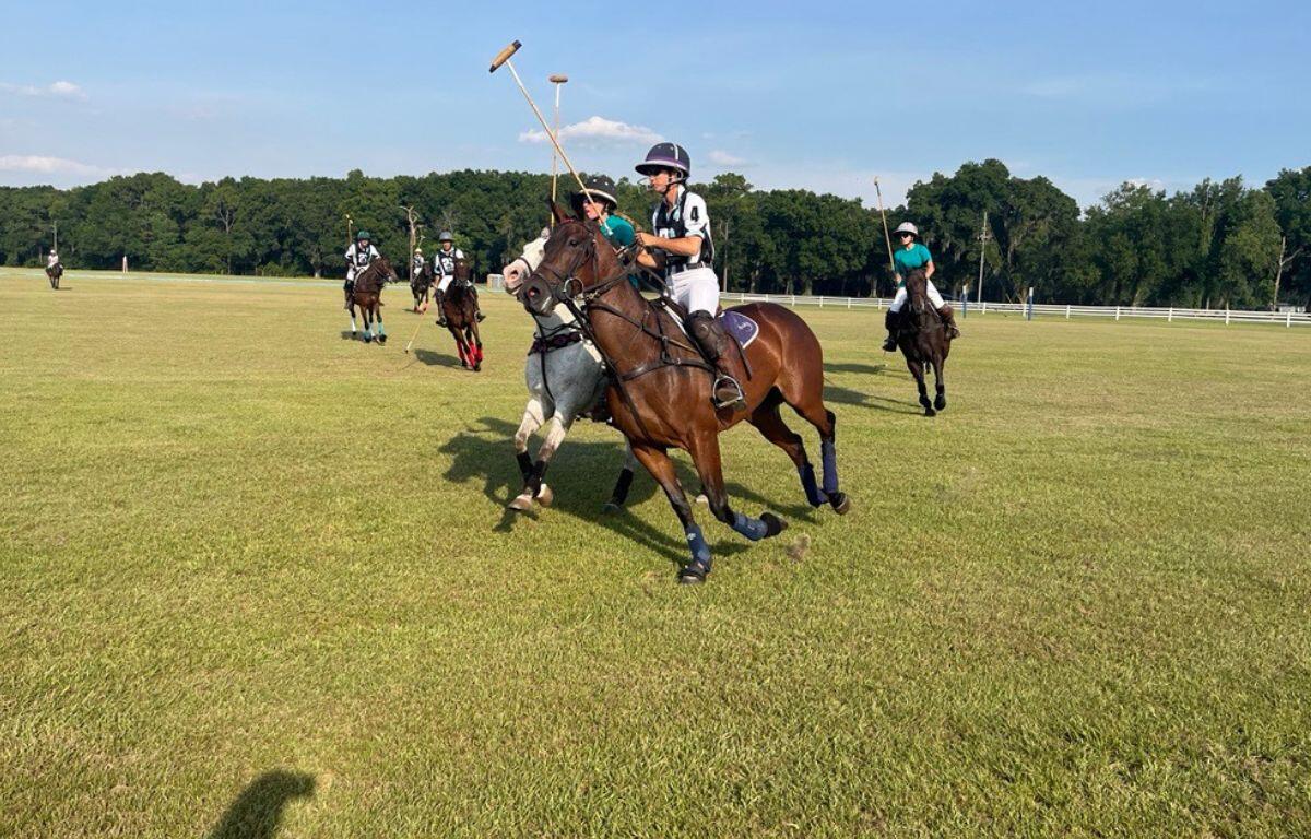 Lauren Proctor-Brown (white sleeves) and Laura Willson (green jersey) attempt to ride each other off in a game at the Ocala Polo Club at the Florida Horse Park on June 1, 2024. Courtesy: Ben Baugh/352today