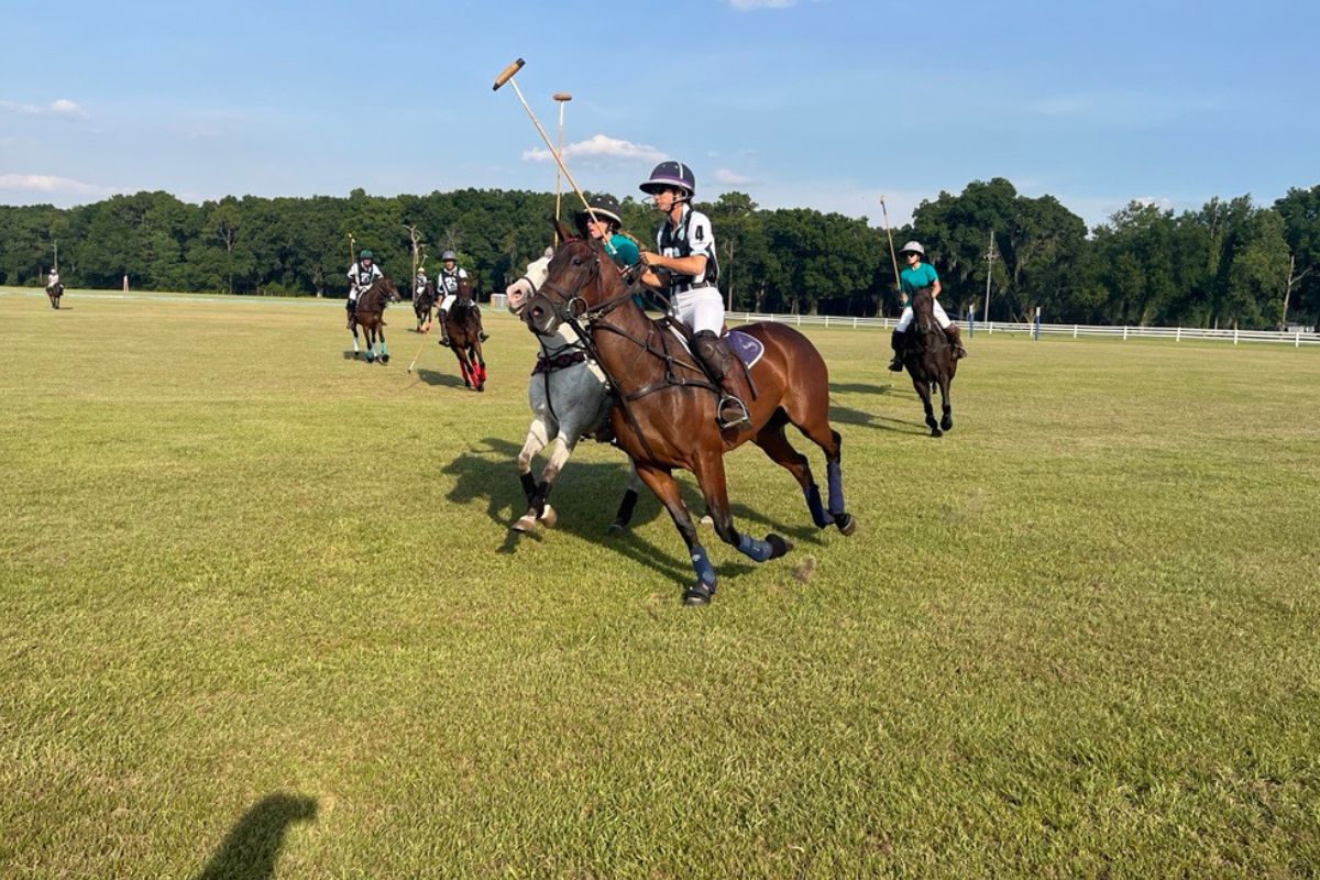 Lauren Proctor-Brown (white sleeves) and Laura Willson (green jersey) attempt to ride each other off in a game at the Ocala Polo Club at the Florida Horse Park on June 1, 2024. Courtesy: Ben Baugh/352today