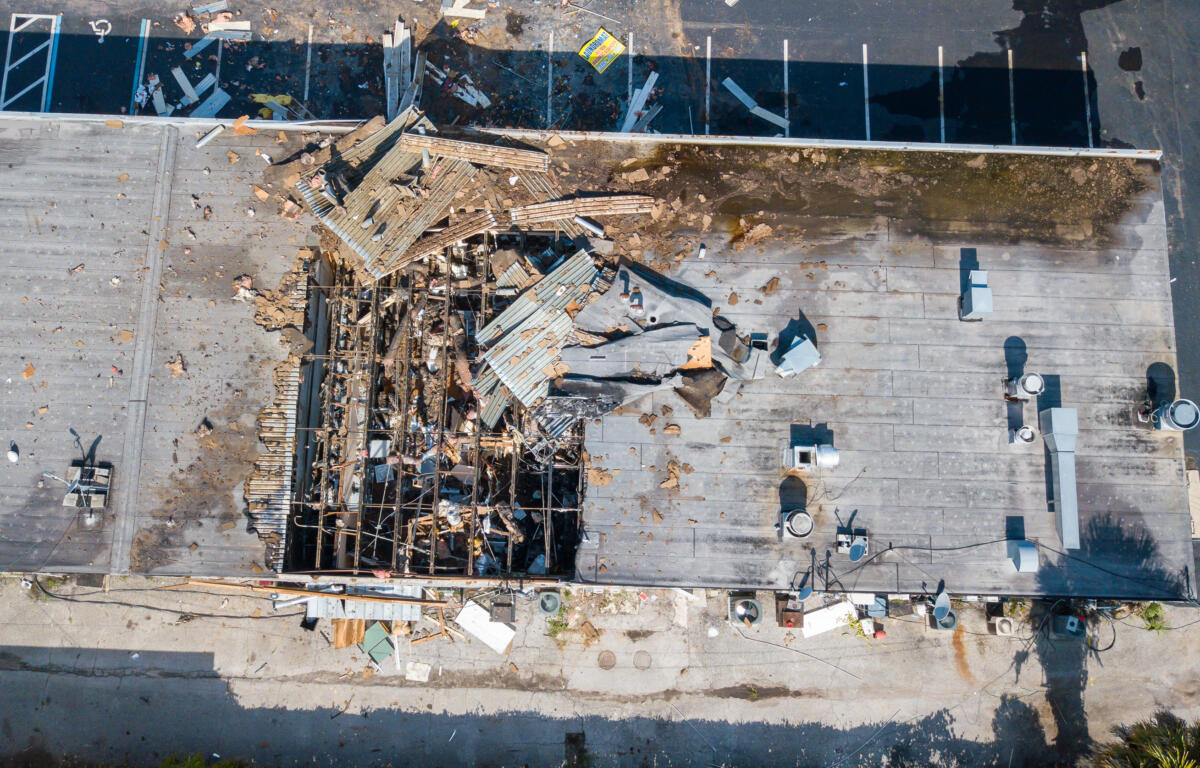 Image shows damage to the roof of the strip mall that housed the Classic Laundromat where the explosion occurred on Tuesday, July 30, 2024.