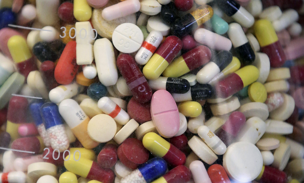 Prescription drugs are seen in a glass flask at a state laboratory.