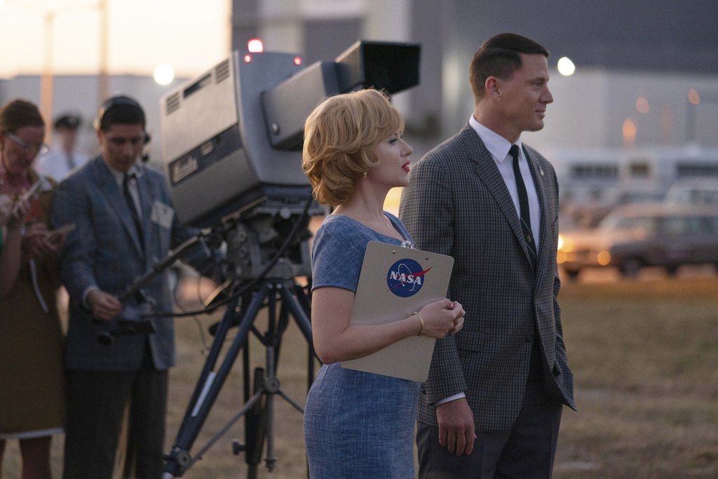 This image released by Apple TV+ shows Scarlett Johansson, center, an Channing Tatum, right, in a scene from "Fly Me to the Moon.