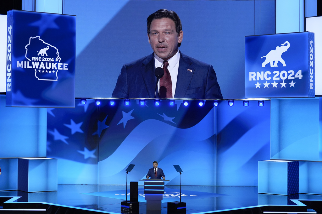 Florida Gov. Ron DeSantis set against the blue backdrop of the Republican National Convention stage in Milwaukee.