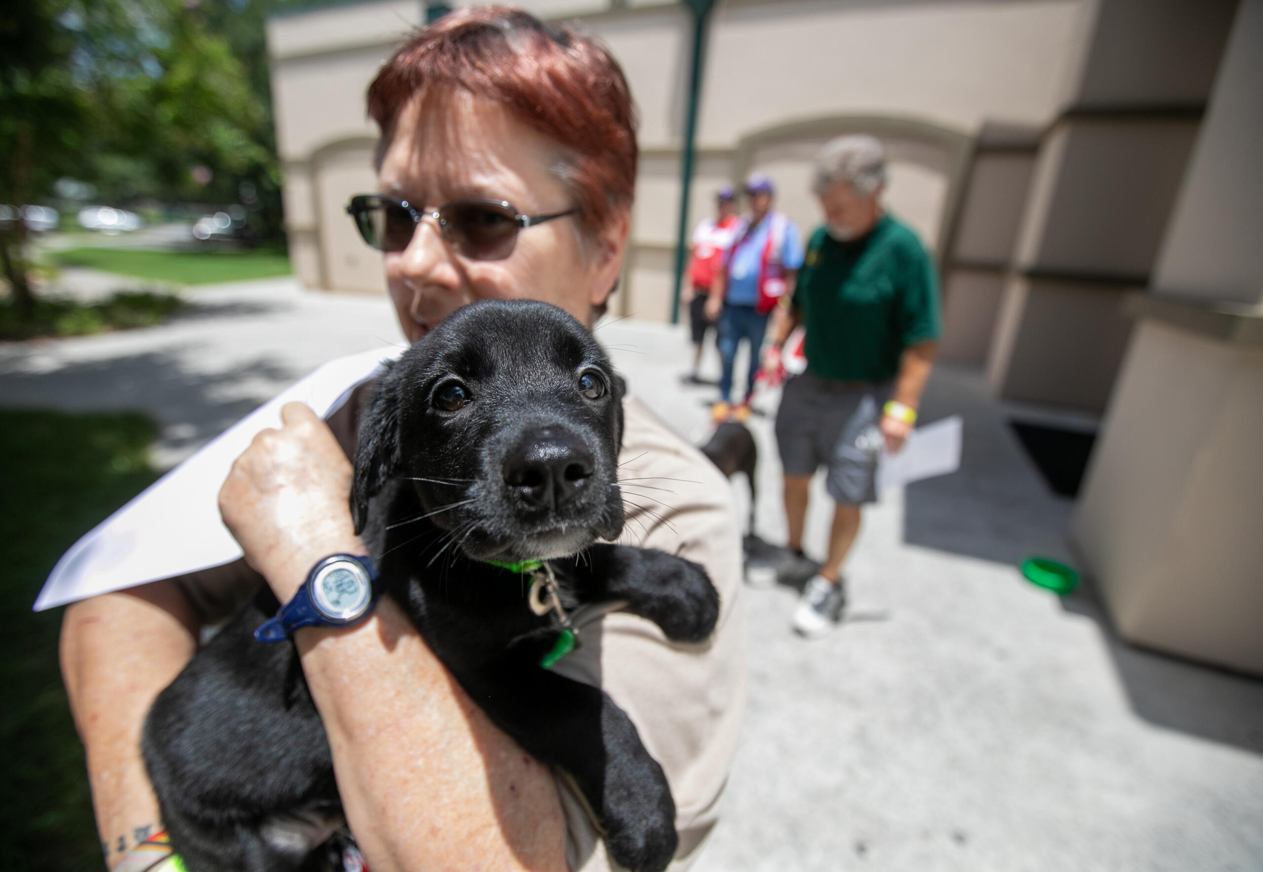 Image shows a woman carrying a dog during a training exercise involving dozens of emergency response agencies in Marion County.