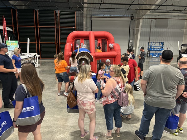 People gathered to try Gator Gobbler's blowup BB gun range at the NCF Outdoor Expo