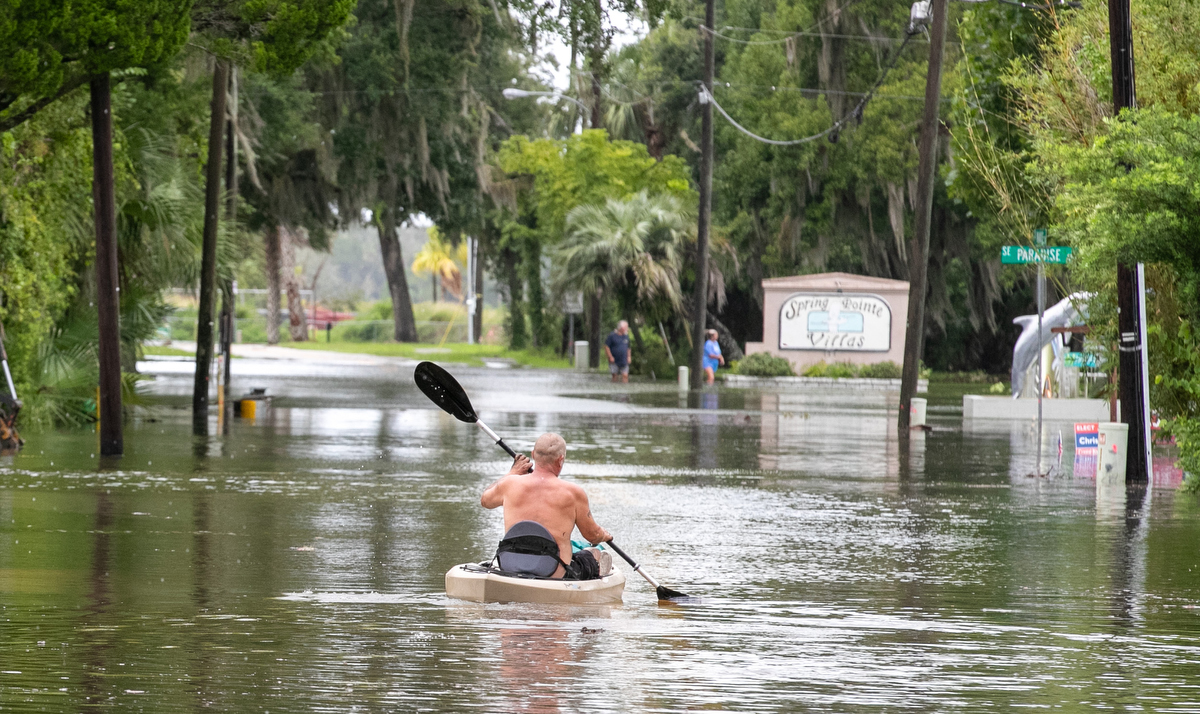 Residents explore the water via kayak in their Paradise Point neighborhood after Hurricane Debby passed Crystal River, FL on Monday, August 5, 2024.