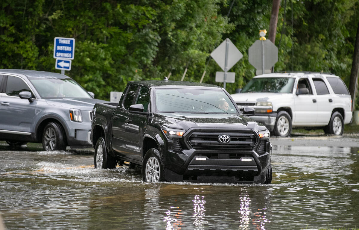 Trucks try the water along Three Sisters Trail after Hurricane Debby passed Crystal River, FL on Monday, August 5, 2024. T