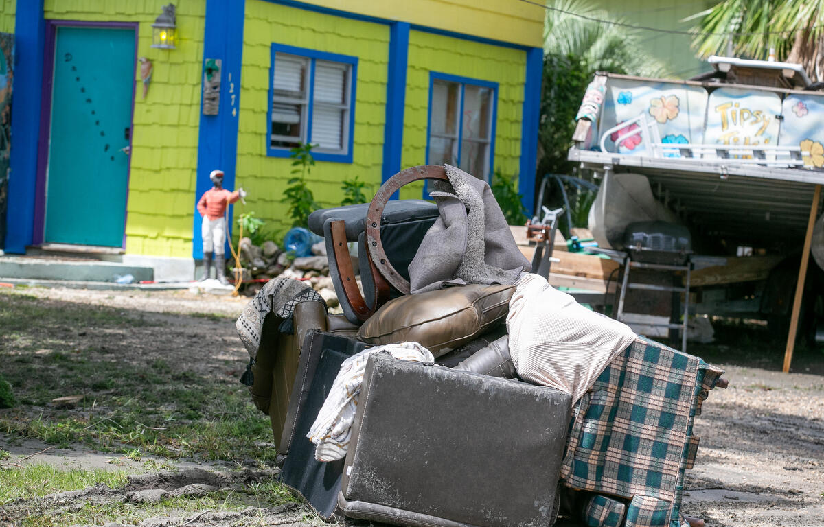Damaged furnishings on Windsor Avenue are piled up outside a home, waiting to be picked up after Hurricane Debby passed Cedar Key, FL.