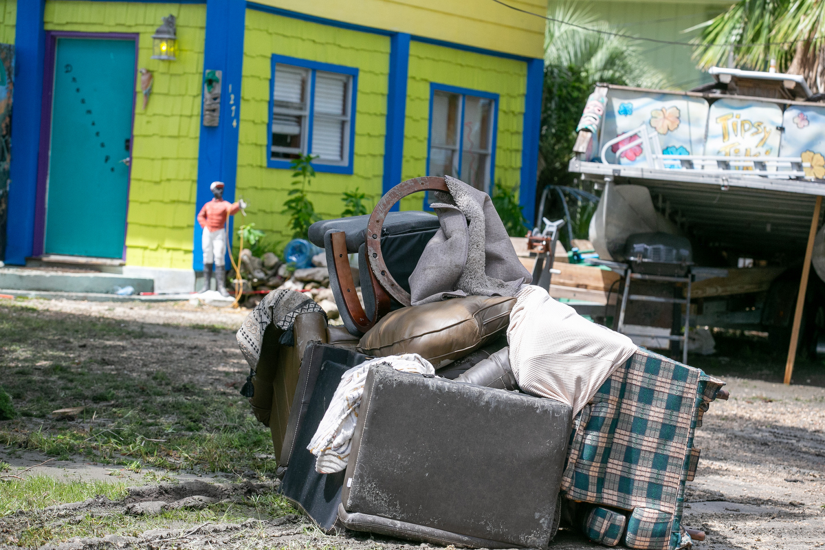 Damaged furnishings on Windsor Avenue are piled up outside a home, waiting to be picked up after Hurricane Debby passed Cedar Key, FL.