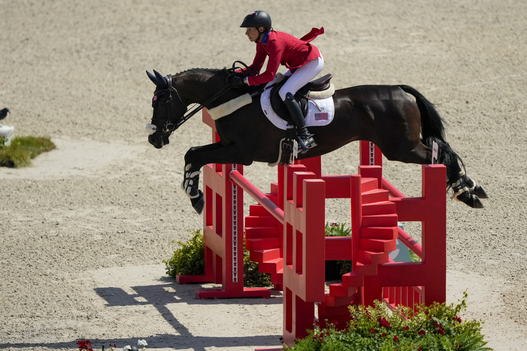Image shows Marion County-based equestrian, Elisabeth Halliday and her horse Nutcracker clearing a jumping hurdle while competing for Team USA in the equestrian jumping event at the 2024 Summer Olympics in Paris.