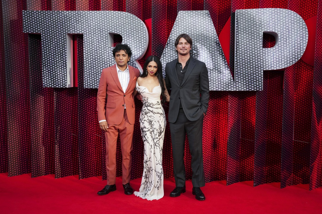 From left: M. Night Shyamalan, Saleka (who stars and is also Shyamalan's daughter) and Josh Hartnett pose for photographers upon arrival at the screening of the film 'Trap' in London.