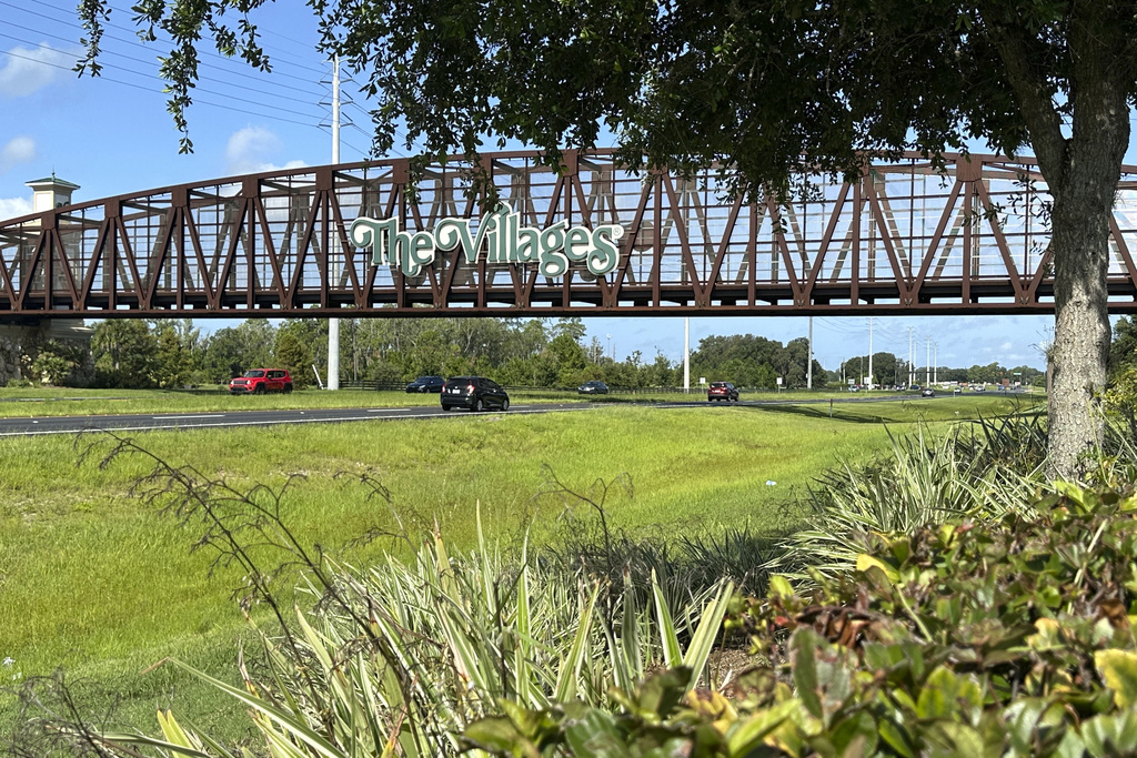 Image shows the golf cart bridge over I-75 that says The Villages.