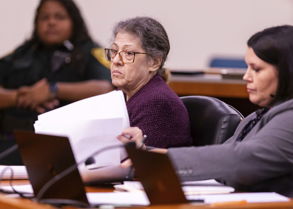 Susan Lorincz, left, seated in a courtroom, listens to testimony during her trial.
