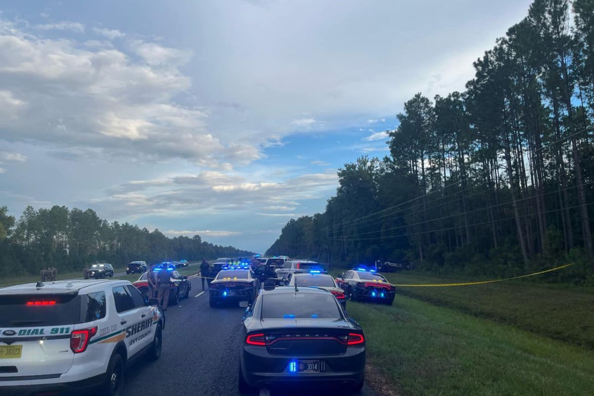 Image shows more than a dozen law enforcement officers blocking U.S. Highway 19.