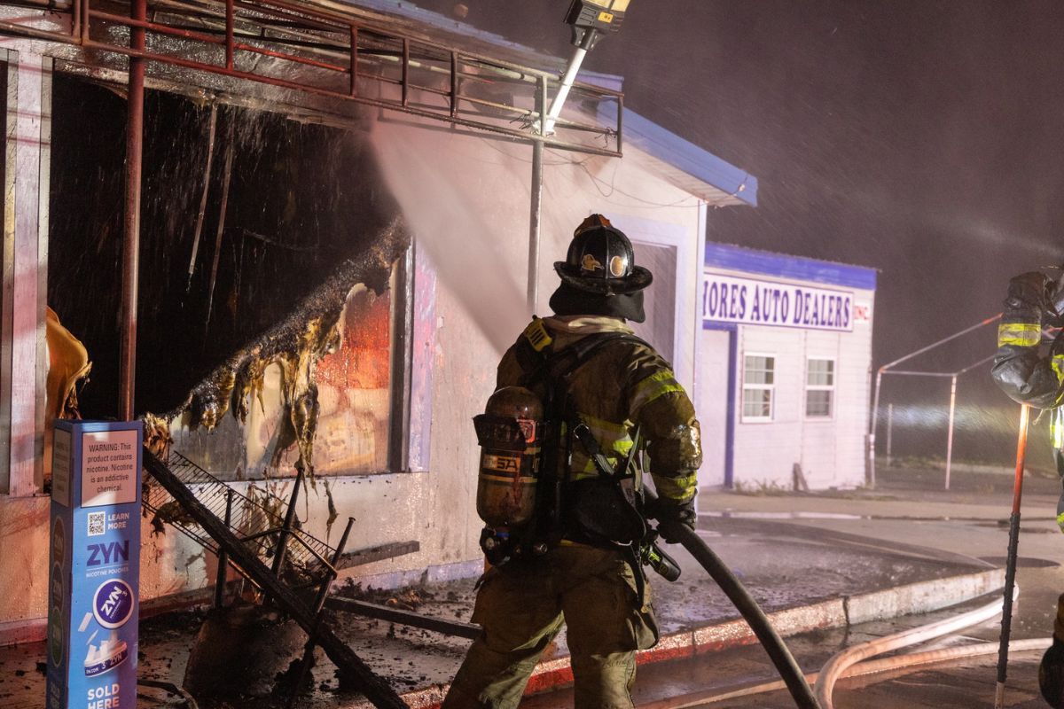 Photo shows firefighters extinguishing the convenience store blaze.