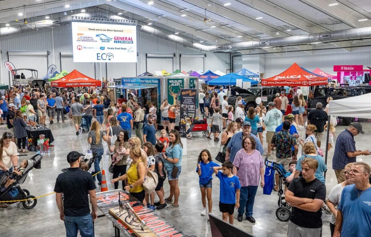 Visitors enjoy the booths and displays at the NCFL Outdoor Expo at the World Equestrian Center in Ocala.