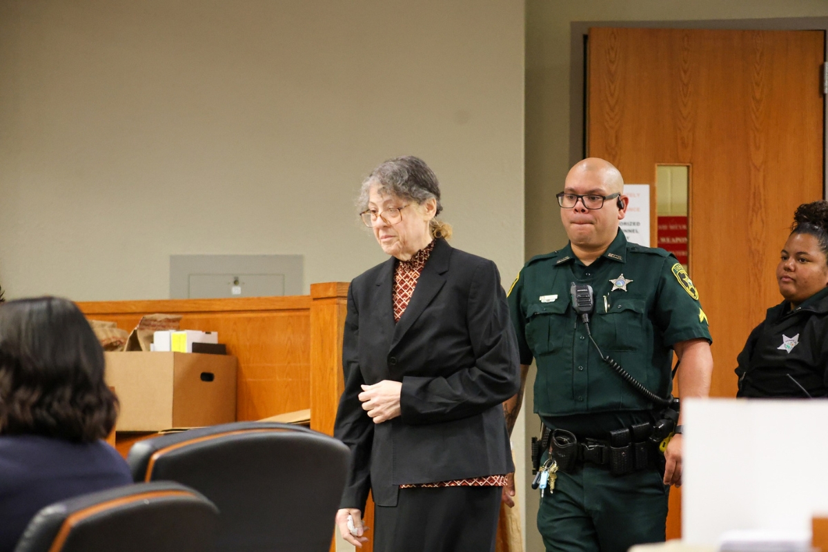 A Marion County deputy walks behind Susan Lorincz at the Marion County Courthouse in Ocala.