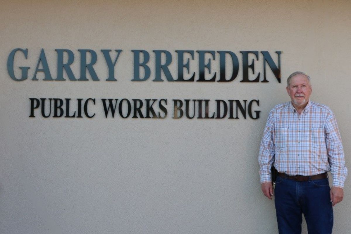 Garry Breeden stands alongside the Public Works Building which now bears his name.