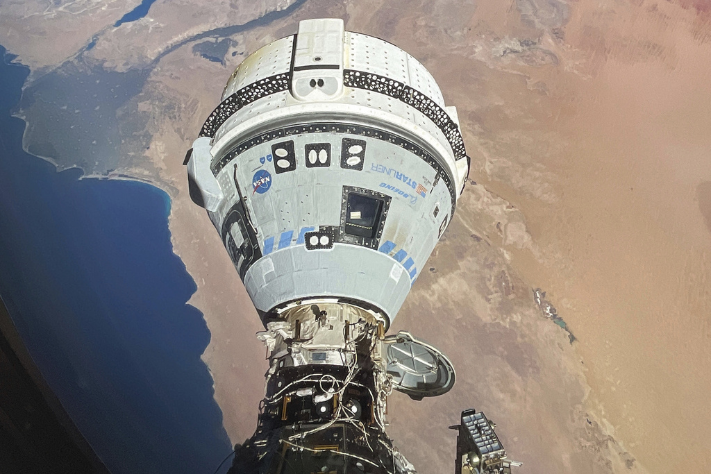 This photo provided by NASA shows the Starliner spacecraft docked to the Harmony module of the International Space Station, orbiting 262 miles above Egypt's Mediterranean coast, on June 13, 2024.