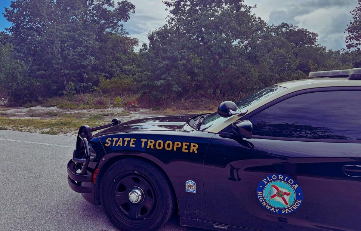 A Florida Highway Patrol cruiser blocks a roadway during a traffic incident.