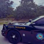 A Florida Highway Patrol cruiser blocks a roadway during a traffic incident.
