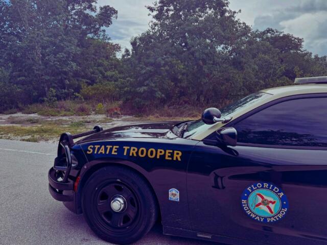 A Florida Highway Patrol cruiser blocks a roadway during a traffic incident.