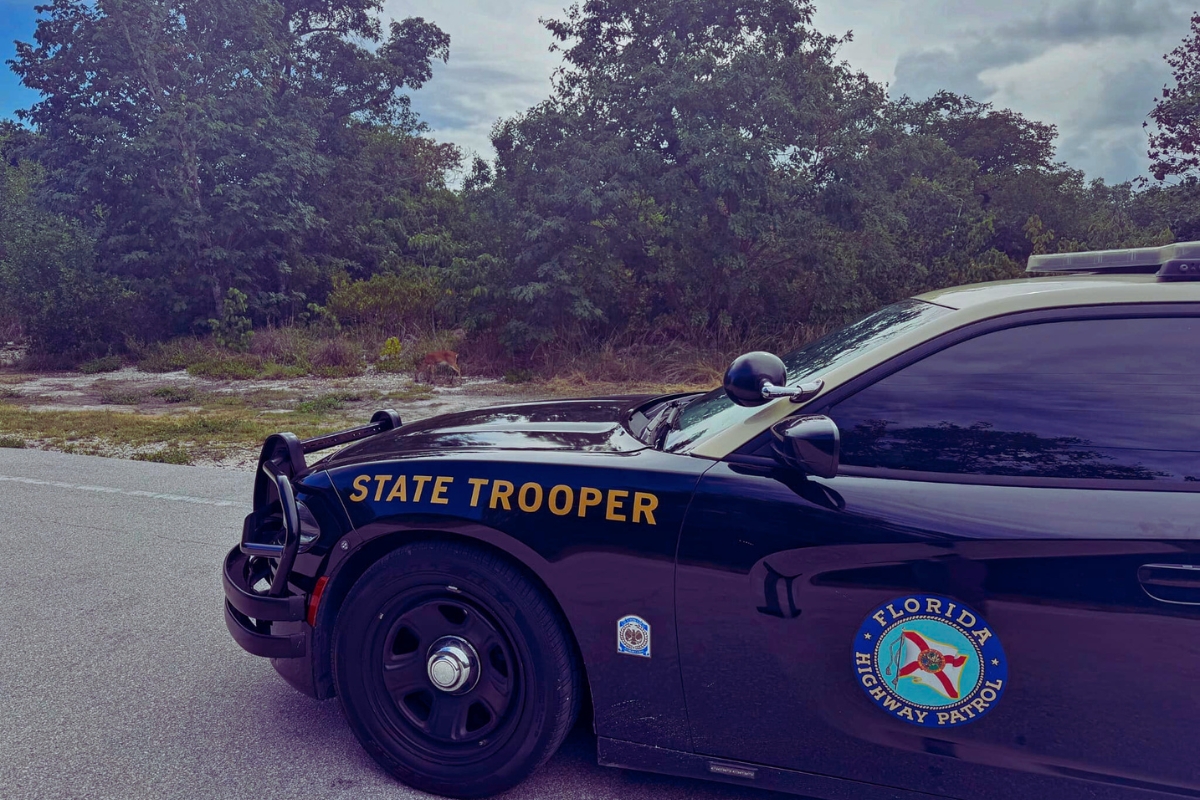 A Florida Highway Patrol cruiser blocks a roadway during a traffic incident.