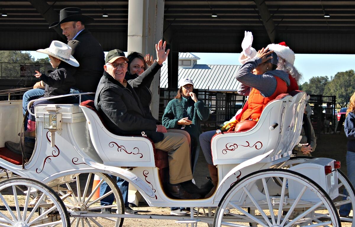 Former City of Ocala Mayor Kent Guinn and Louisa Barton, Ocala Metro CEP director of equine initiative and organizer of the All-Breed Parade ride in a carriage during the event on Nov. 23, 2024, at the Florida Horse Park.