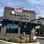 Ellianos Coffee decorates exterior of building with festive flowers and scare crow decorations.