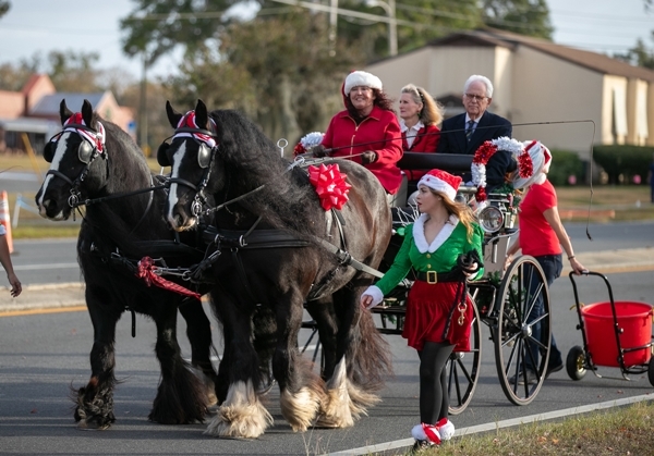 The team from Big Sexy Stables carried Grand Marshal former Ocala Mayor Kent Guinn and his wife Sandra during the annual Ocala Christmas Parade.