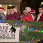 Kids wave from the Silver River Museum float during the annual Ocala Christmas Parade.