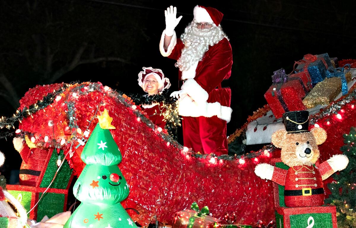 Santa waves to fans as he is the last float during the annual Ocala Christmas Parade.