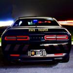 Florida Highway Patrol cruiser parked at night with emergency lights on