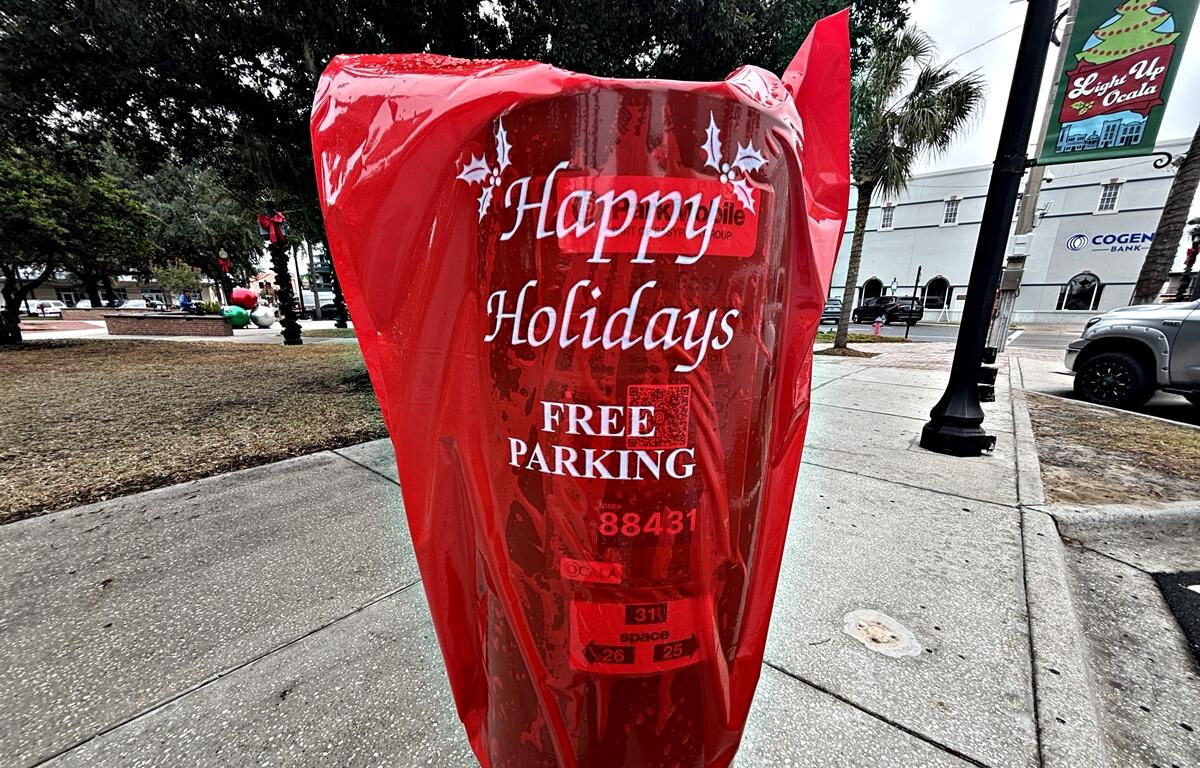 Red bags cover parking meters in downtown Ocala, signaling free parking for residents and visitors through Jan. 2 as part of the city’s holiday season celebration.