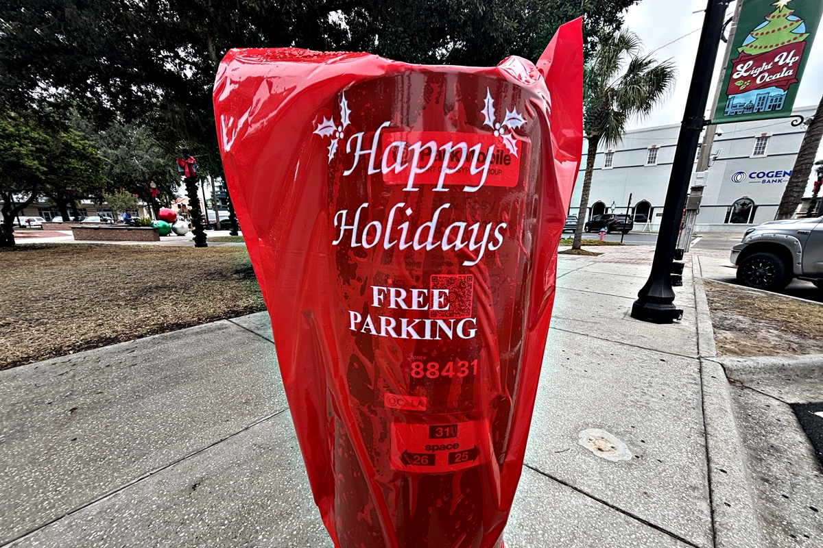 Red bags cover parking meters in downtown Ocala, signaling free parking for residents and visitors through Jan. 2 as part of the city’s holiday season celebration.