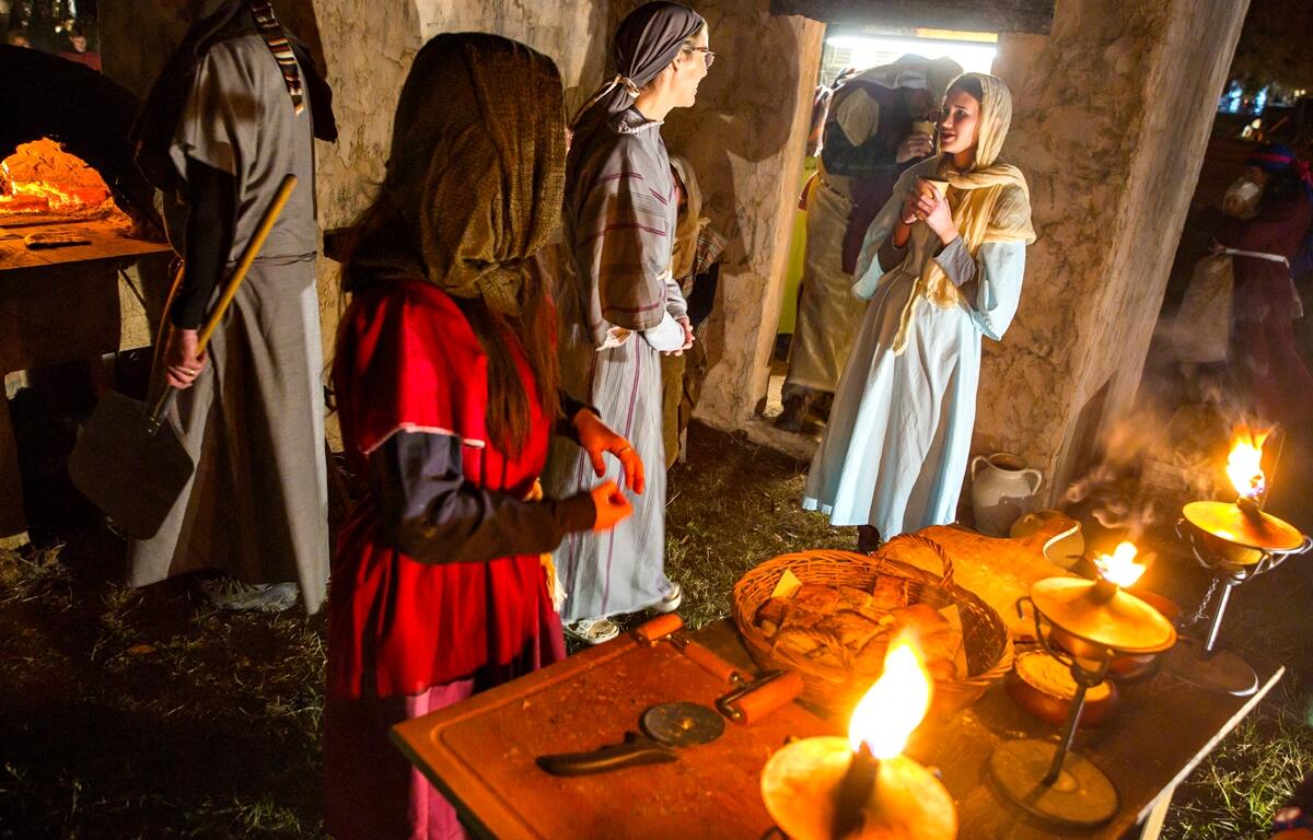 Cast members make bread as thousands traveled through the live history of Christianity and spent a moment with the Baby Jesus during the 29th Annual Good Shepherd Presbyterian Living Nativity Pageant. Sunday, Dec. 22, 2024, in Ocala, Fla.