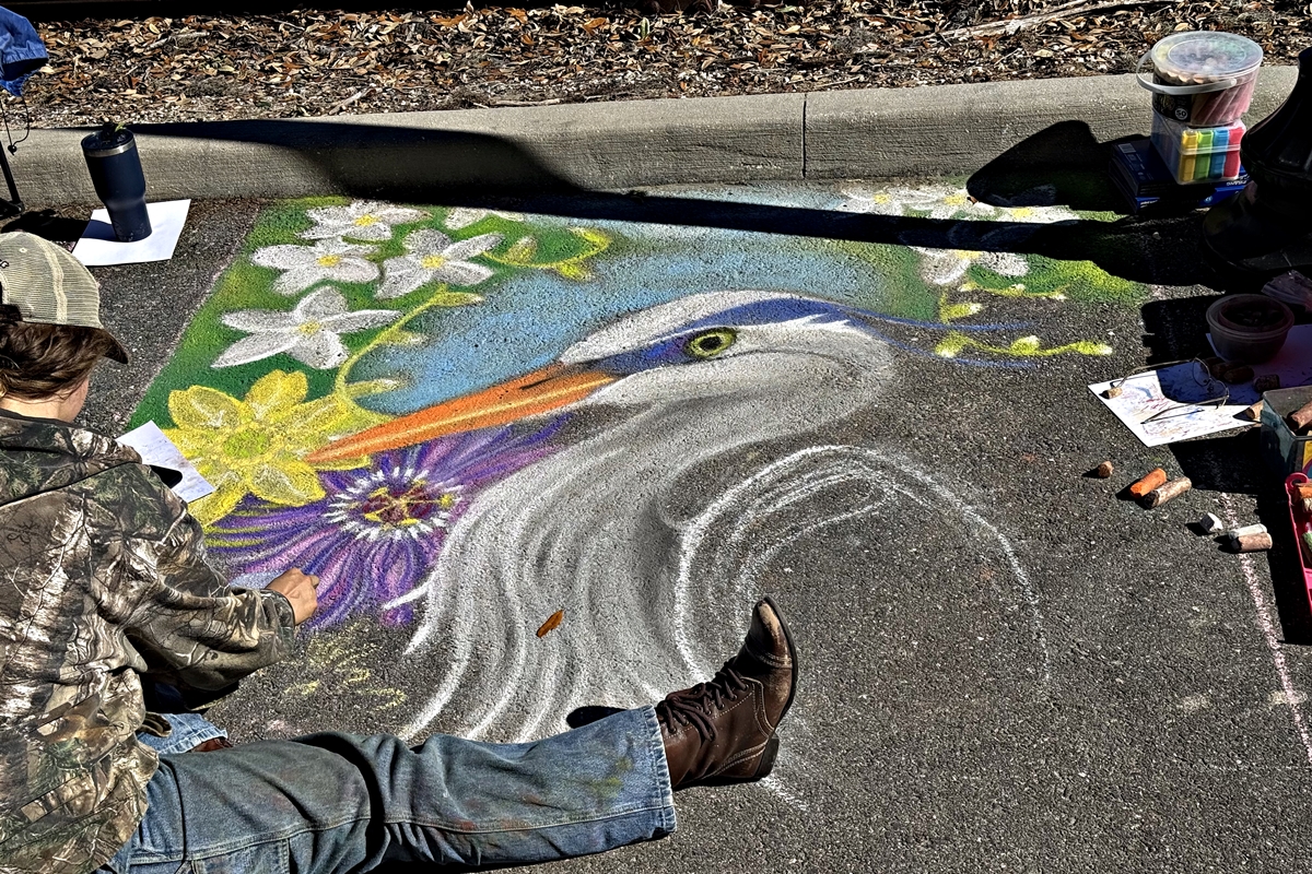 Participants showcase their chalk art at the 2025 OTrak Chalk Walk Competition held at Tuscawilla Art Park in Ocala, with winners receiving cash prizes and recognition for their creative talents.