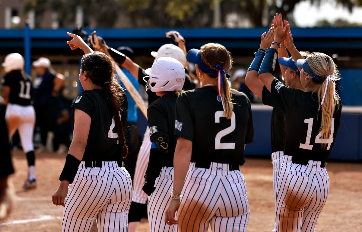 CF softball players erupt in celebration after a big inning during their final day sweep at the JUCO Kickoff Classic.