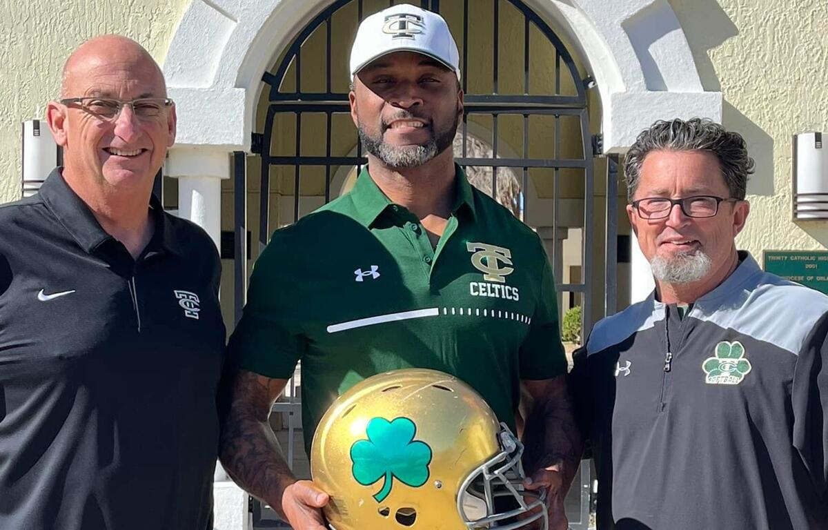 Trinity Catholic High School President Lou Pereira (left), newly appointed head football coach Clint Hart (center), and Athletic Director Mike Young (right) celebrate Hart’s introduction as the leader of the Celtic Nation football program.