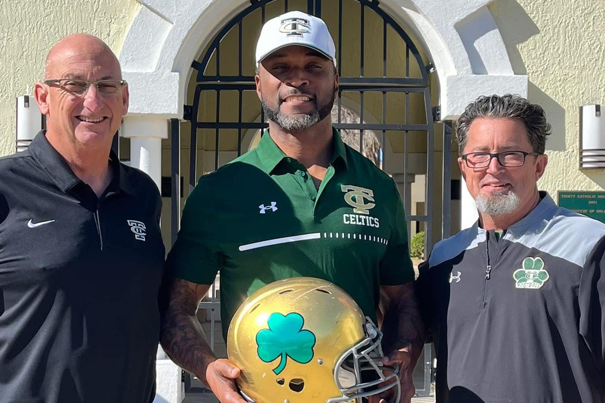Trinity Catholic High School President Lou Pereira (left), newly appointed head football coach Clint Hart (center), and Athletic Director Mike Young (right) celebrate Hart’s introduction as the leader of the Celtic Nation football program.