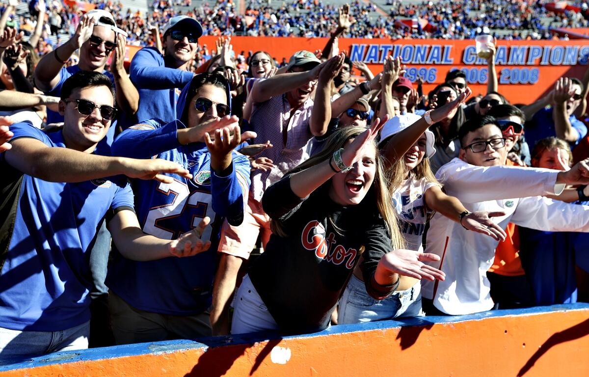 Florida fans do the 'Gator Chomp' as they cheer during the second half of an NCAA college football game against Idaho, Saturday, Nov. 17, 2018, in Gainesville, FL.