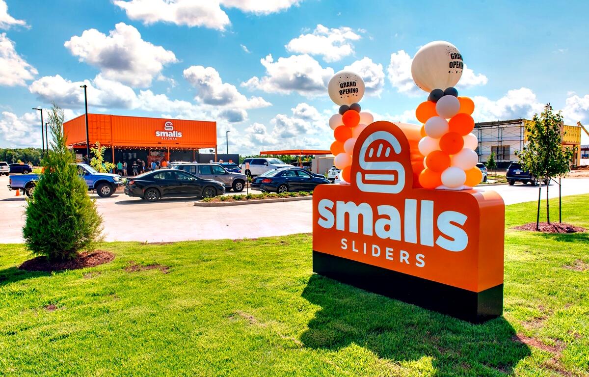 Smalls Sliders employees and community members celebrate the opening of the brand’s newest location in Ocala.