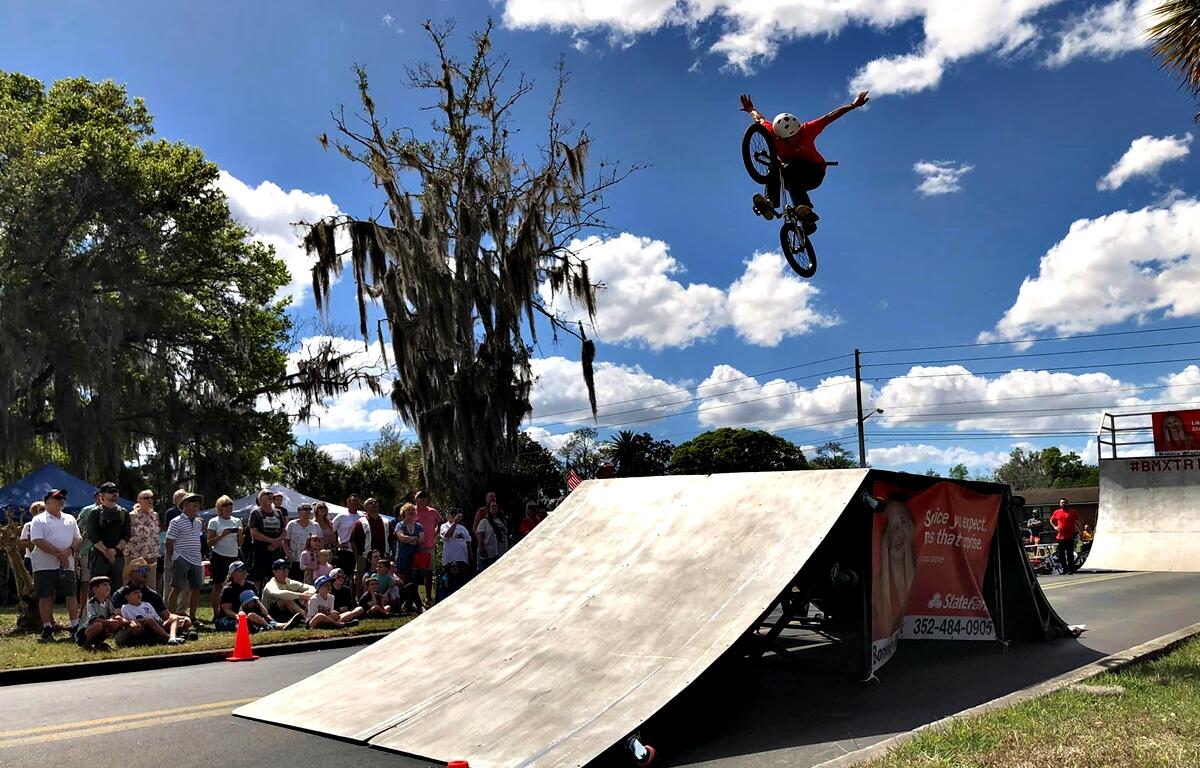 BMX riders soar through the air during a stunt show at the Habitat Ocala Strawberry Festival in Ocala, Fla., where guests can enjoy more than just fresh strawberries.